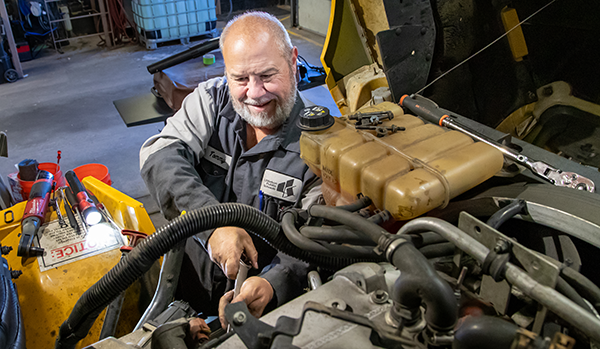 Photo: Bus transportation mechanic working on bus